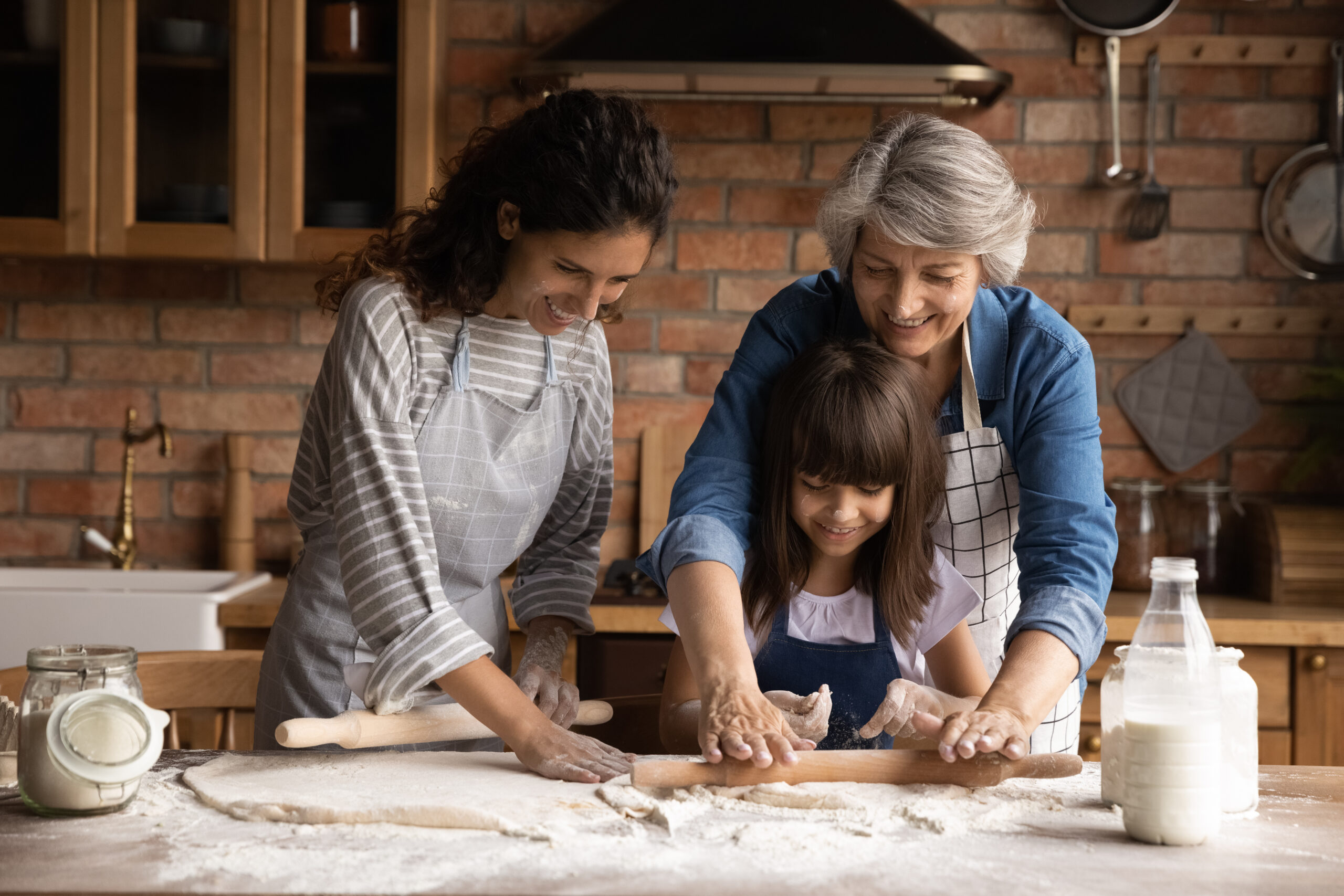 Hispanic family rolling dough with a rolling pin